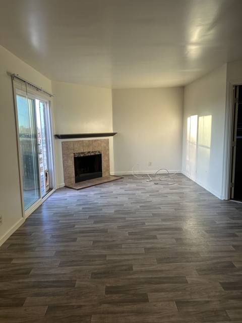 Updated one-bedroom: living room with tile fireplace and slider to the deck